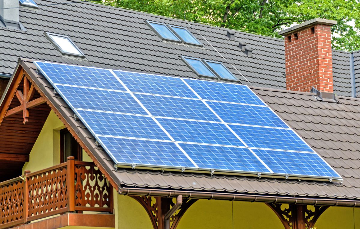 Solar panels on house with skylights and brick chimney