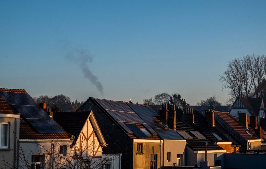 Residential rooftops with solar panels at golden hour