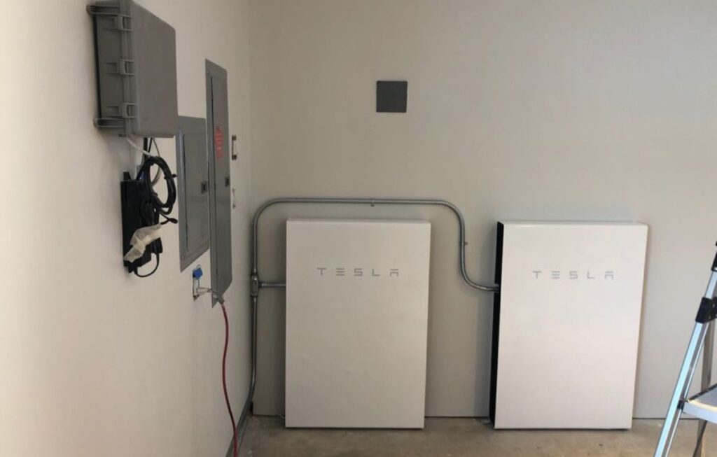 Tesla Powerwall home battery units mounted on garage wall