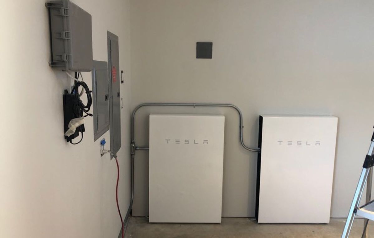 Tesla Powerwall home battery units mounted on garage wall