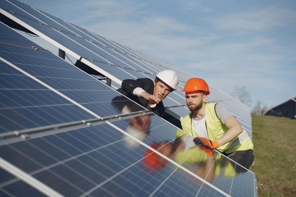 Solar experts performing a site assessment on a ground-mounted solar array