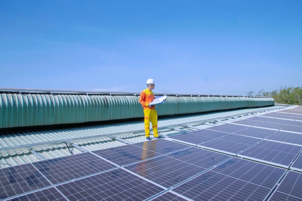 Solar technician inspecting a roof to determine if a property is not suitable for solar panel installation