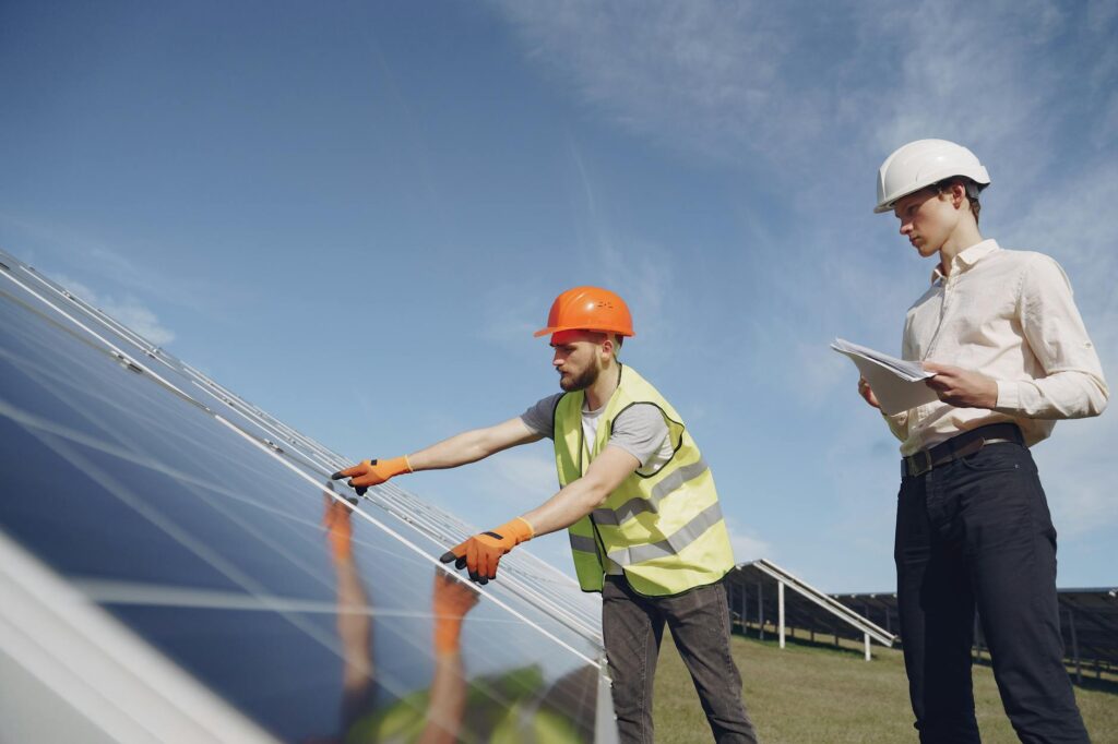Solar engineers evaluating panel placement and tilt angle during a professional solar site assessment