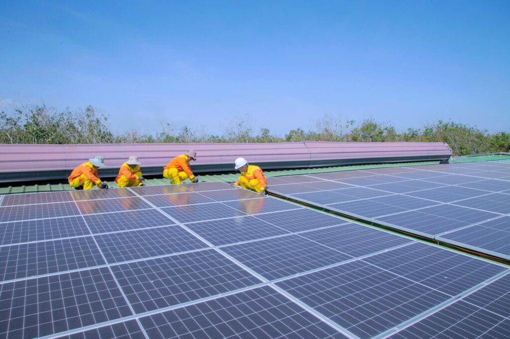 Professional team installing residential solar panels on a roof