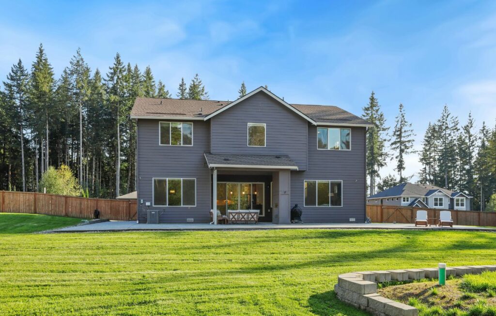 Large two-story home with spacious backyard, representing solar thermal property value